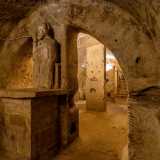 Proseguiamo in fondo al vano. Alle nostre spalle, su un altare posto in una nicchia in pietra ricavata da un pilastro, si erge la statua di San Cleto benedicente, segno che la grotta serv� in seguito come luogo religioso